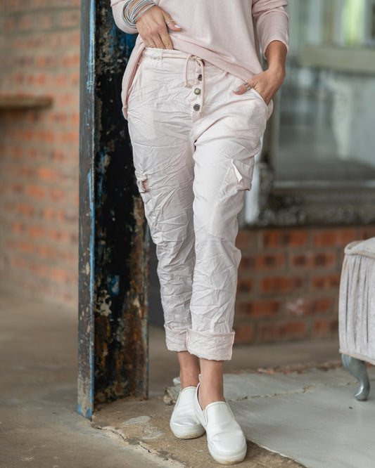 There is nothing "plain" about these pants - our elasticated drawstring pants with a button-up feature. Deep side pockets for practicality, these pants strike the perfect balance between style and functionality. The adjustable drawstring waist ensures a personalized fit, while the classic silhouette offers versatility for any occasion