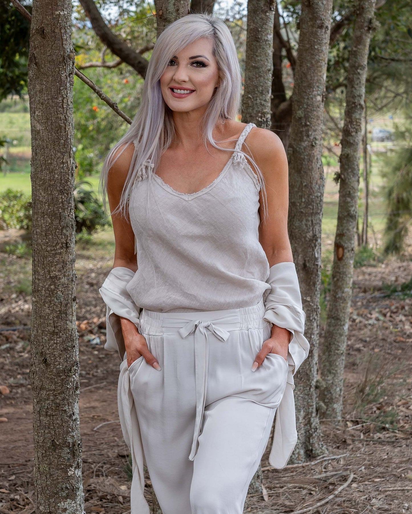 This charming cami is a must have item in your wardrobe. This piece is all about the details, featuring a raw edge finish that gives it a chic, understated look, and plated decorative straps that elevate its style. The natural linen fabric is breathable and lightweight, ensuring you stay cool and comfortable all day long. Perfect for layering or wearing on its own, this cami brings together rustic elegance and modern design