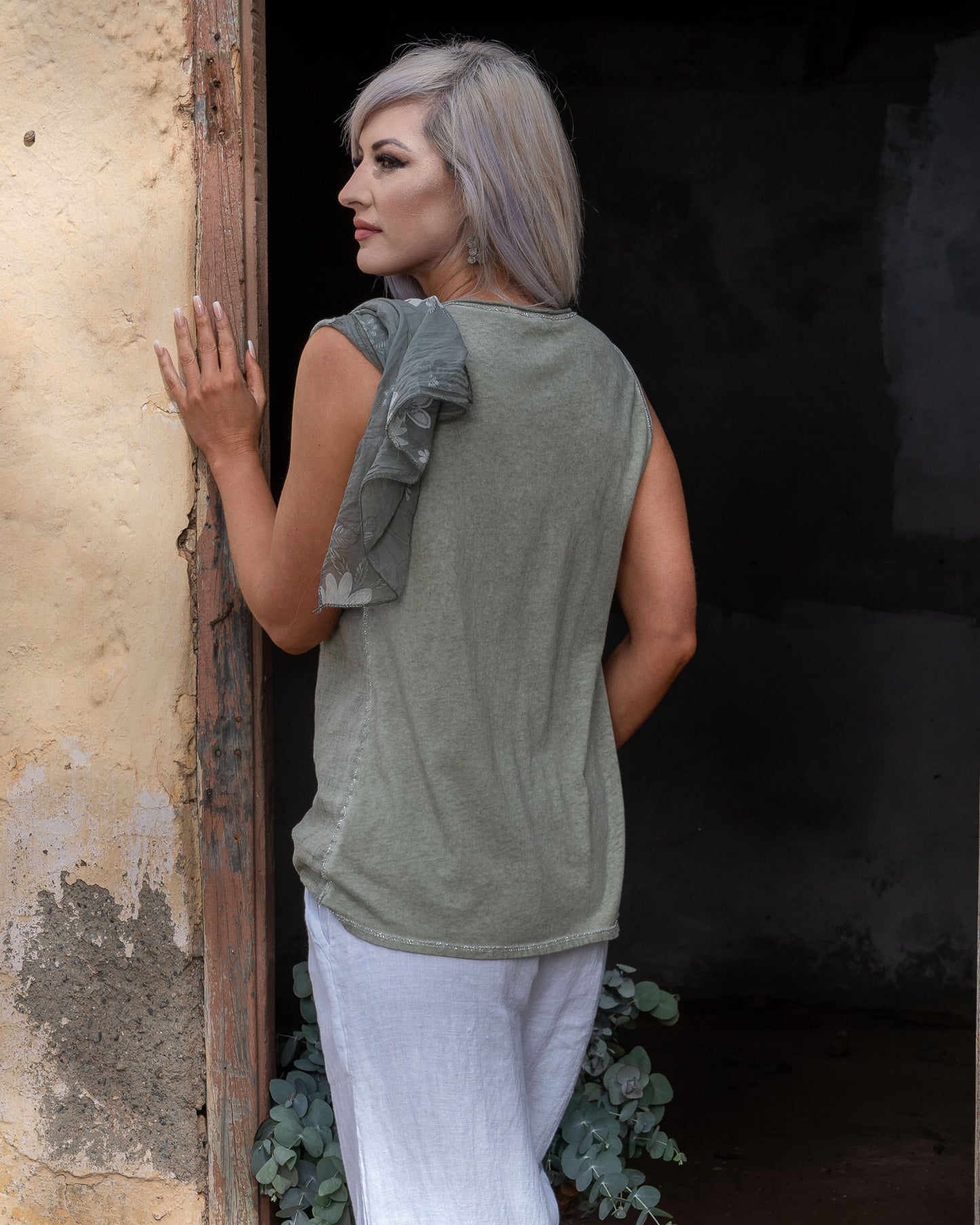 Crafted from 100% linen, this tank style cami offers a breathable, lightweight feel that keeps you cool and comfortable. The silver script detail adds a touch of elegance, while the decorative pocket provides a stylish accent. Finished with silver threading all around, this top exudes subtle glamour, making it ideal for both relaxed days and more polished occasions. Whether paired with your favorite jeans or layered under a jacket, this cami is a versatile piece that adds a refined touch to any outfit