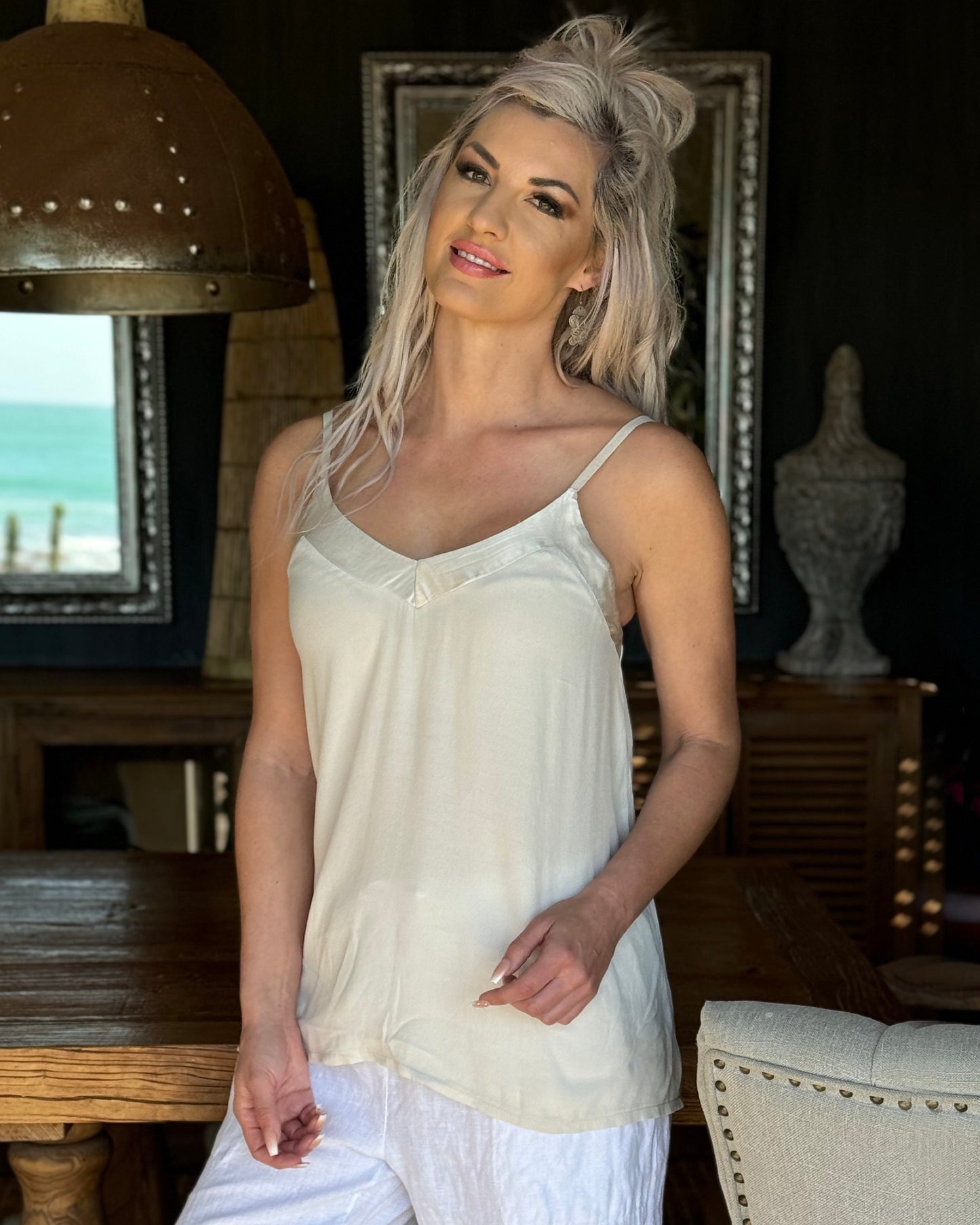 Perfect addition to add to your essentials. This cami features delicate straps and luxurious silky inserts around the bust, adding a touch of elegance to a classic design. Crafted from breathable fabric, it offers a cool and airy feel, making it perfect for layering or wearing on its own during warmer days. Whether you're dressing up for a night out or keeping it casual, this cami combines style and comfort for a versatile wardrobe staple