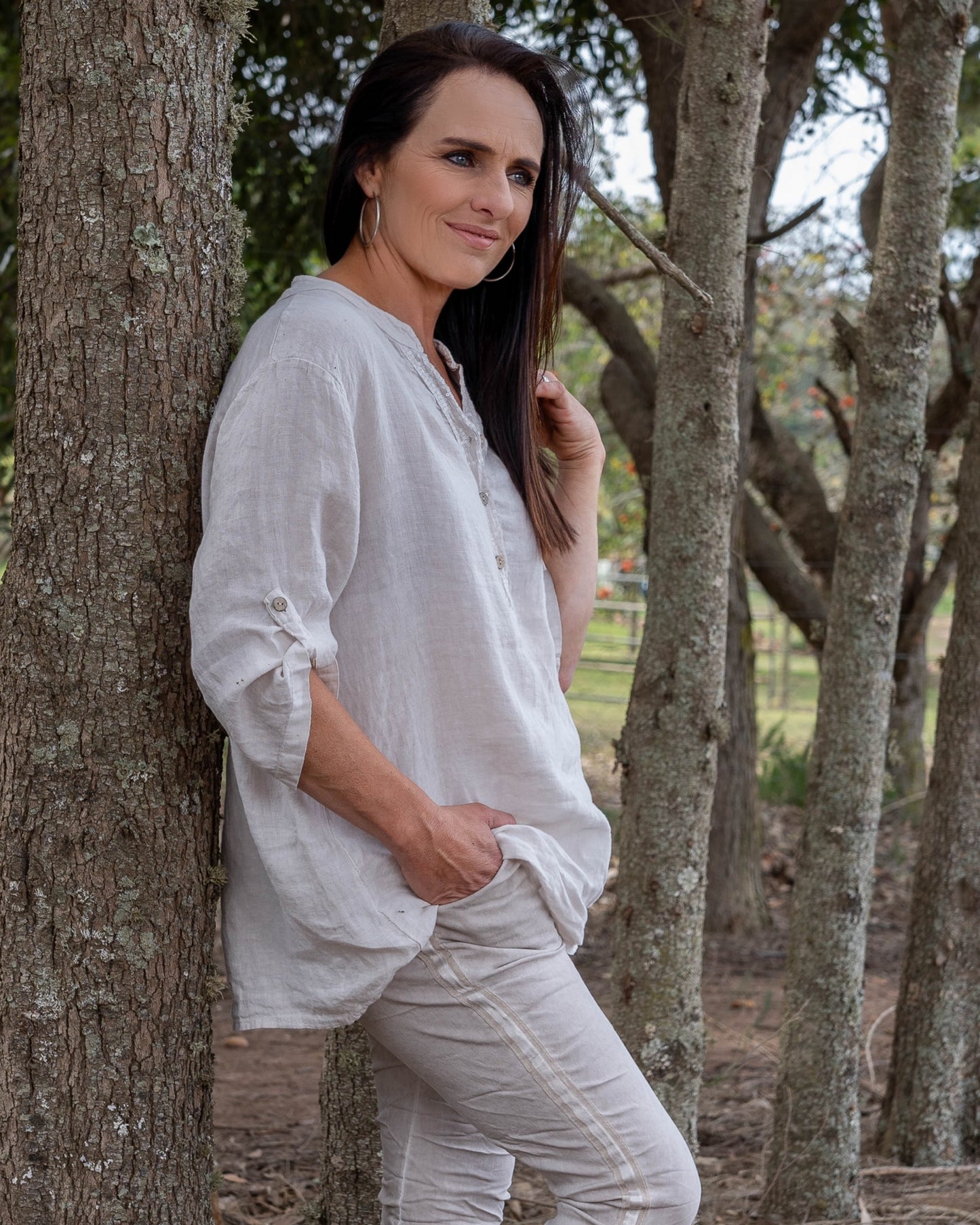 One of our all time favourites - now in Linen!&nbsp;This top features a dazzling sequin insert that adds a touch of sparkle, complemented by wooden button-down detailing that brings a natural, earthy charm. A sequin pocket enhances the visual appeal with a subtle shimmer. The 3/4 sleeves come with a convenient pull-up tab, allowing you to adjust your look to suit any occasion. Crafted from pure linen, this top combines breathability with a chic design