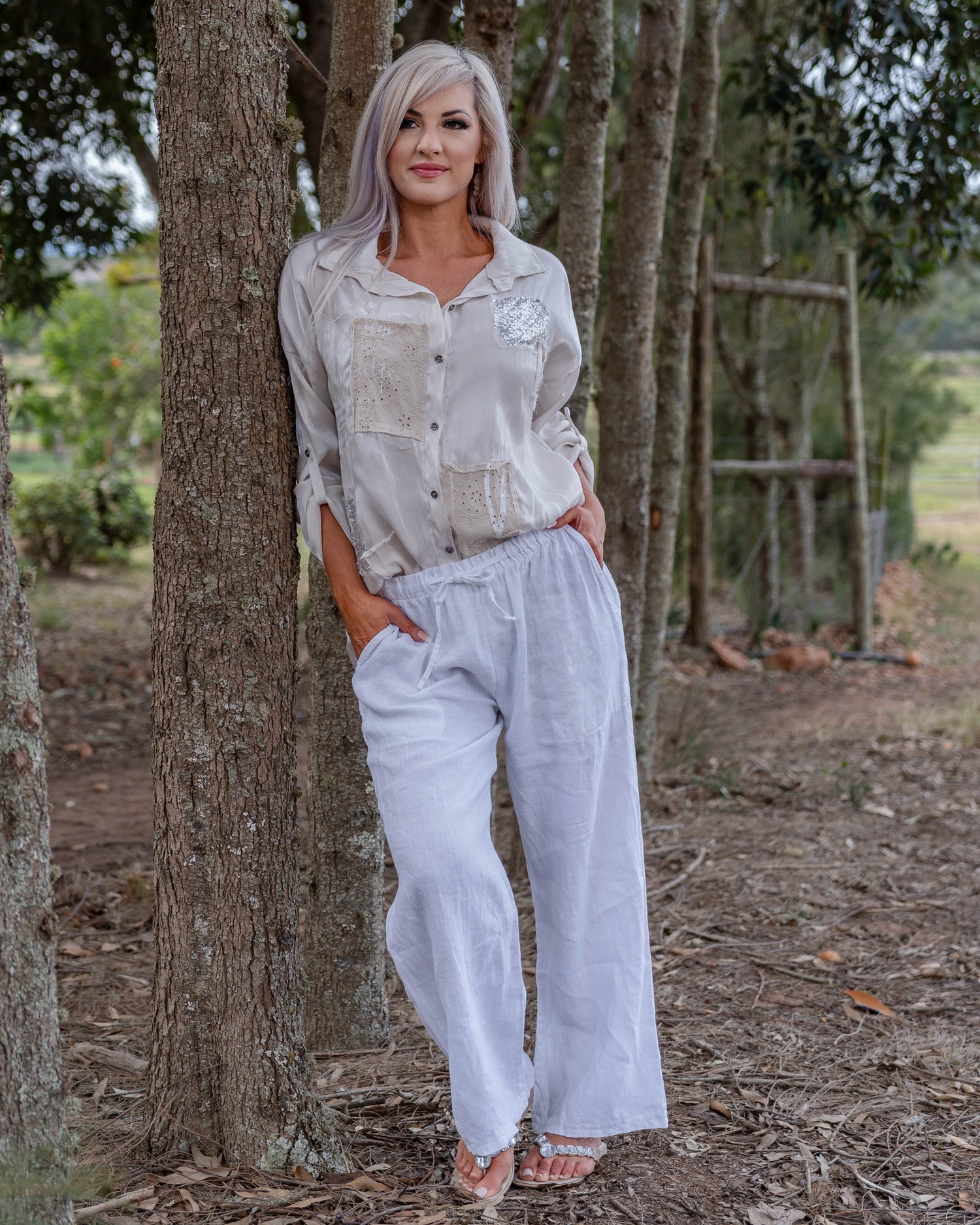 The perfect blend of comfort and style. These high-waisted pants feature an elasticated waistband with a functional drawstring. The slight wide-leg design creates a relaxed yet elegant silhouette, making these pants a versatile choice for any occasion.&nbsp;Designed with deep side pockets, these pants are as practical as they are chic, offering ample space to carry your essentials. Crafted from pure linen, they provide a breathable and lightweight feel, keeping you cool and comfortable throughout the day