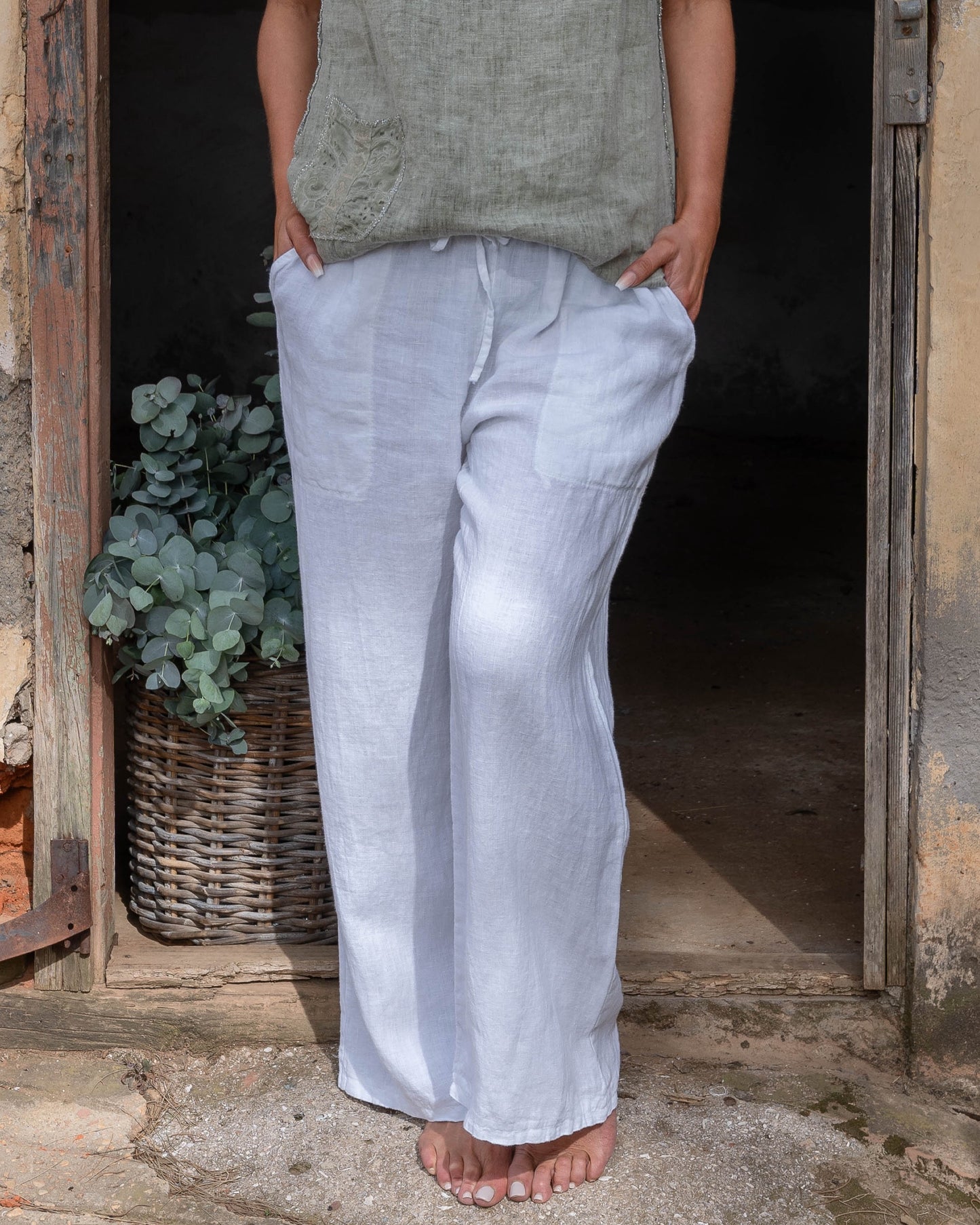 The perfect blend of comfort and style. These high-waisted pants feature an elasticated waistband with a functional drawstring. The slight wide-leg design creates a relaxed yet elegant silhouette, making these pants a versatile choice for any occasion.&nbsp;Designed with deep side pockets, these pants are as practical as they are chic, offering ample space to carry your essentials. Crafted from pure linen, they provide a breathable and lightweight feel, keeping you cool and comfortable throughout the day