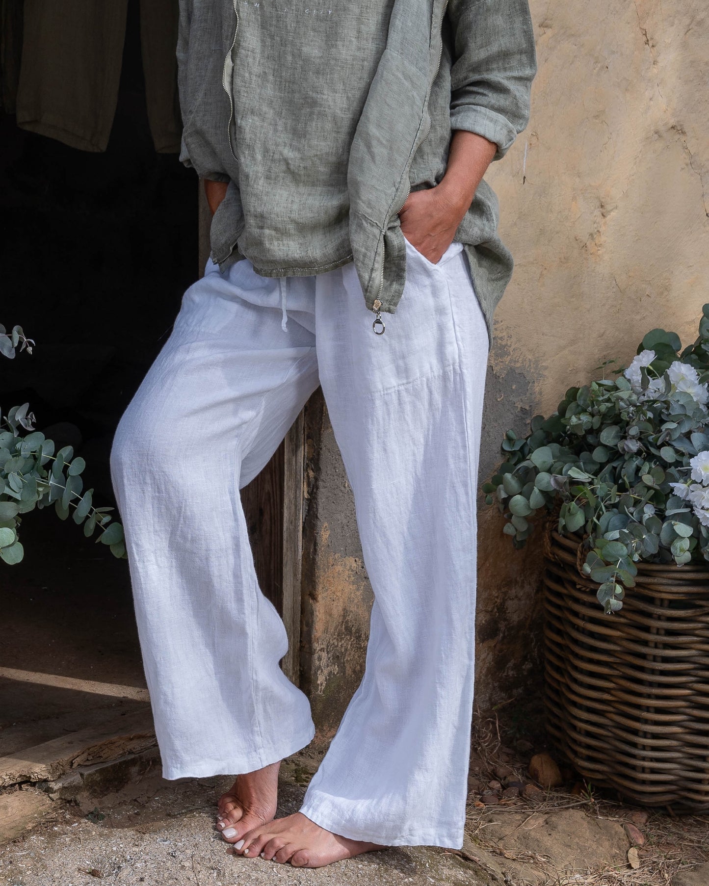 The perfect blend of comfort and style. These high-waisted pants feature an elasticated waistband with a functional drawstring. The slight wide-leg design creates a relaxed yet elegant silhouette, making these pants a versatile choice for any occasion.&nbsp;Designed with deep side pockets, these pants are as practical as they are chic, offering ample space to carry your essentials. Crafted from pure linen, they provide a breathable and lightweight feel, keeping you cool and comfortable throughout the day