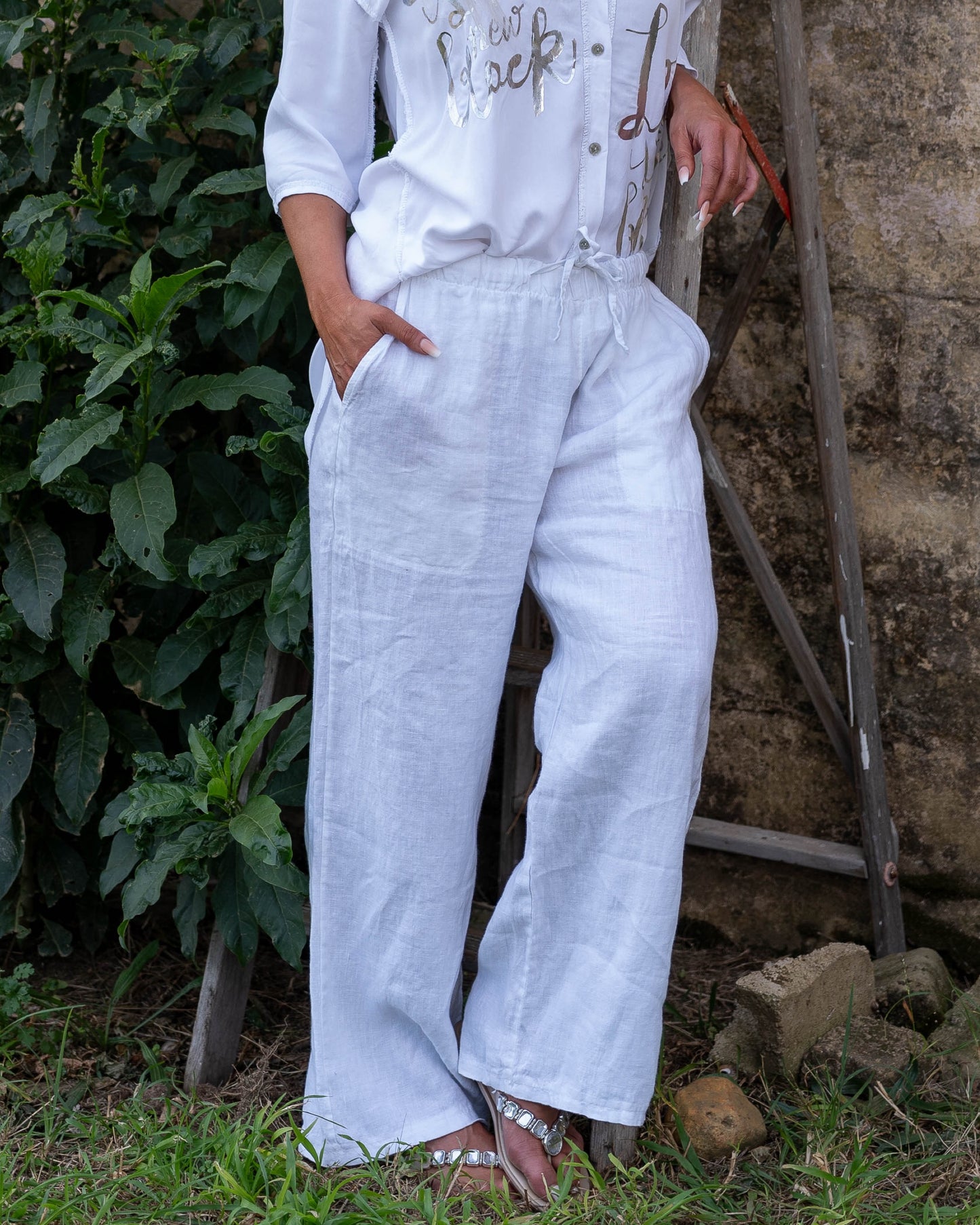 The perfect blend of comfort and style. These high-waisted pants feature an elasticated waistband with a functional drawstring. The slight wide-leg design creates a relaxed yet elegant silhouette, making these pants a versatile choice for any occasion.&nbsp;Designed with deep side pockets, these pants are as practical as they are chic, offering ample space to carry your essentials. Crafted from pure linen, they provide a breathable and lightweight feel, keeping you cool and comfortable throughout the day