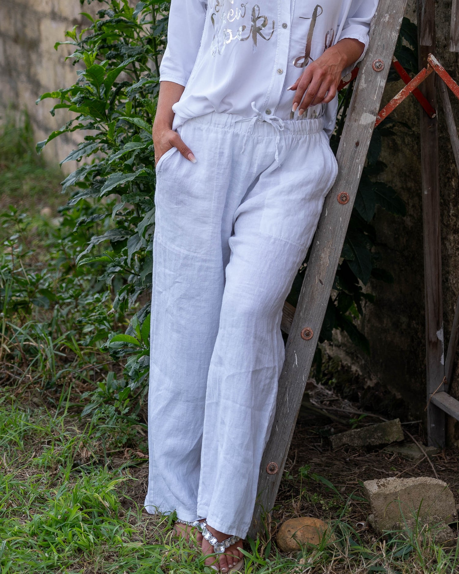 The perfect blend of comfort and style. These high-waisted pants feature an elasticated waistband with a functional drawstring. The slight wide-leg design creates a relaxed yet elegant silhouette, making these pants a versatile choice for any occasion.&nbsp;Designed with deep side pockets, these pants are as practical as they are chic, offering ample space to carry your essentials. Crafted from pure linen, they provide a breathable and lightweight feel, keeping you cool and comfortable throughout the day