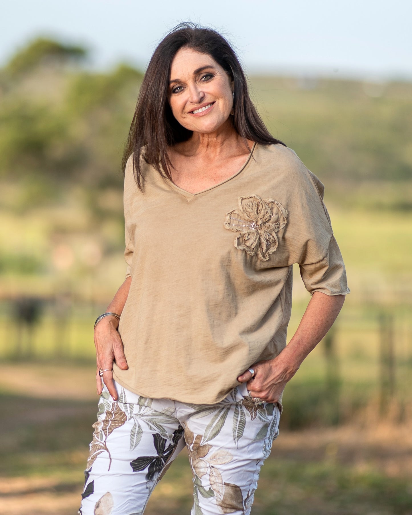 Designed for those who love effortless style on the go. This lightweight and breathable tee features a charming flower decal on the chest, adding a touch of femininity. The raw edge trim gives it a laid-back, modern feel, making it the perfect choice for casual days. Embrace comfort and style in one versatile piece