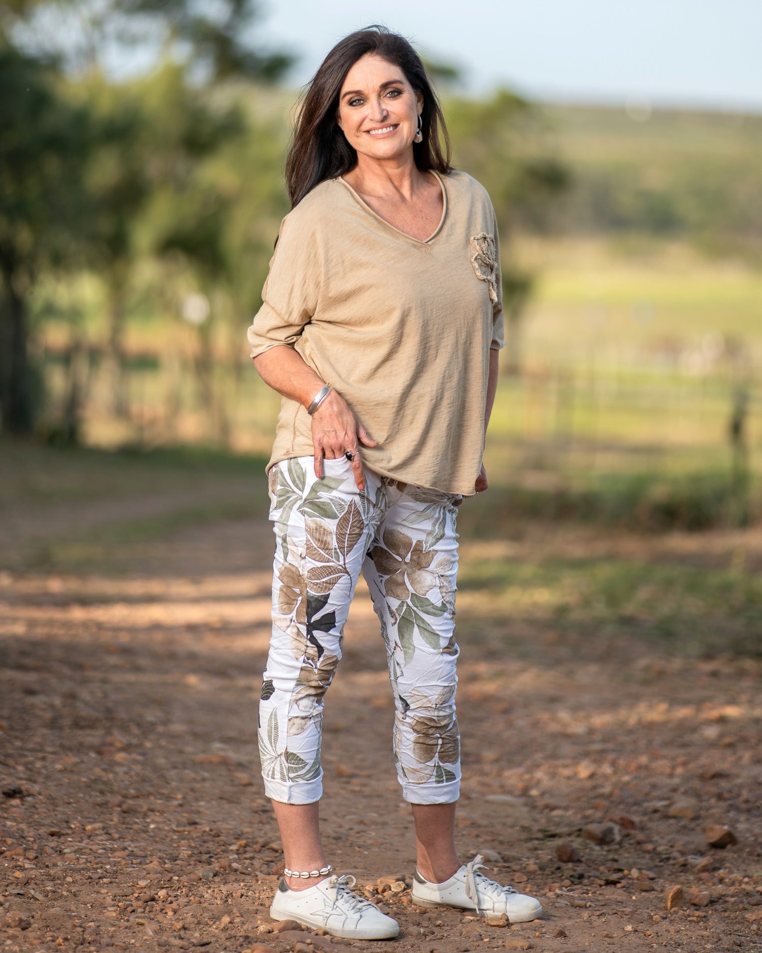 Designed for those who love effortless style on the go. This lightweight and breathable tee features a charming flower decal on the chest, adding a touch of femininity. The raw edge trim gives it a laid-back, modern feel, making it the perfect choice for casual days. Embrace comfort and style in one versatile piece